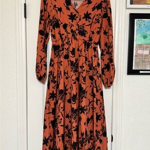 Fall ready dress size M with deep orange & a black floral print.